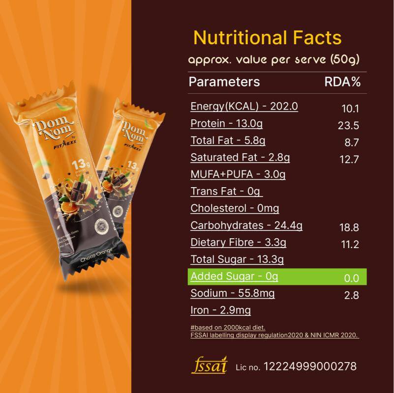 Dom Nom Choco Orange Protein Bar - A delicious and nutritious protein bar with 13g protein, natural sugar, and no chalky taste. Made with 0% added sugar, featuring a clean label for a guilt-free snack. Hand holding the vibrant pink packaging against a berry-themed background