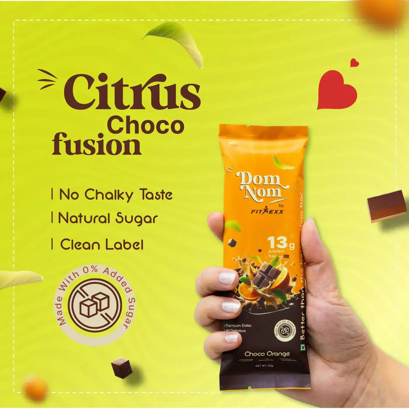 Dom Nom Choco orange Protein Bar - A delicious and nutritious protein bar with 13g protein, natural sugar, and no chalky taste. Made with 0% added sugar, featuring a clean label for a guilt-free snack. Hand holding the vibrant pink packaging against a berry-themed background